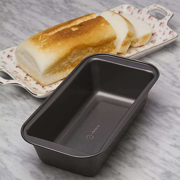 BakeIns Large Non-Stick Loaf Pan on countertop next to bread cooling